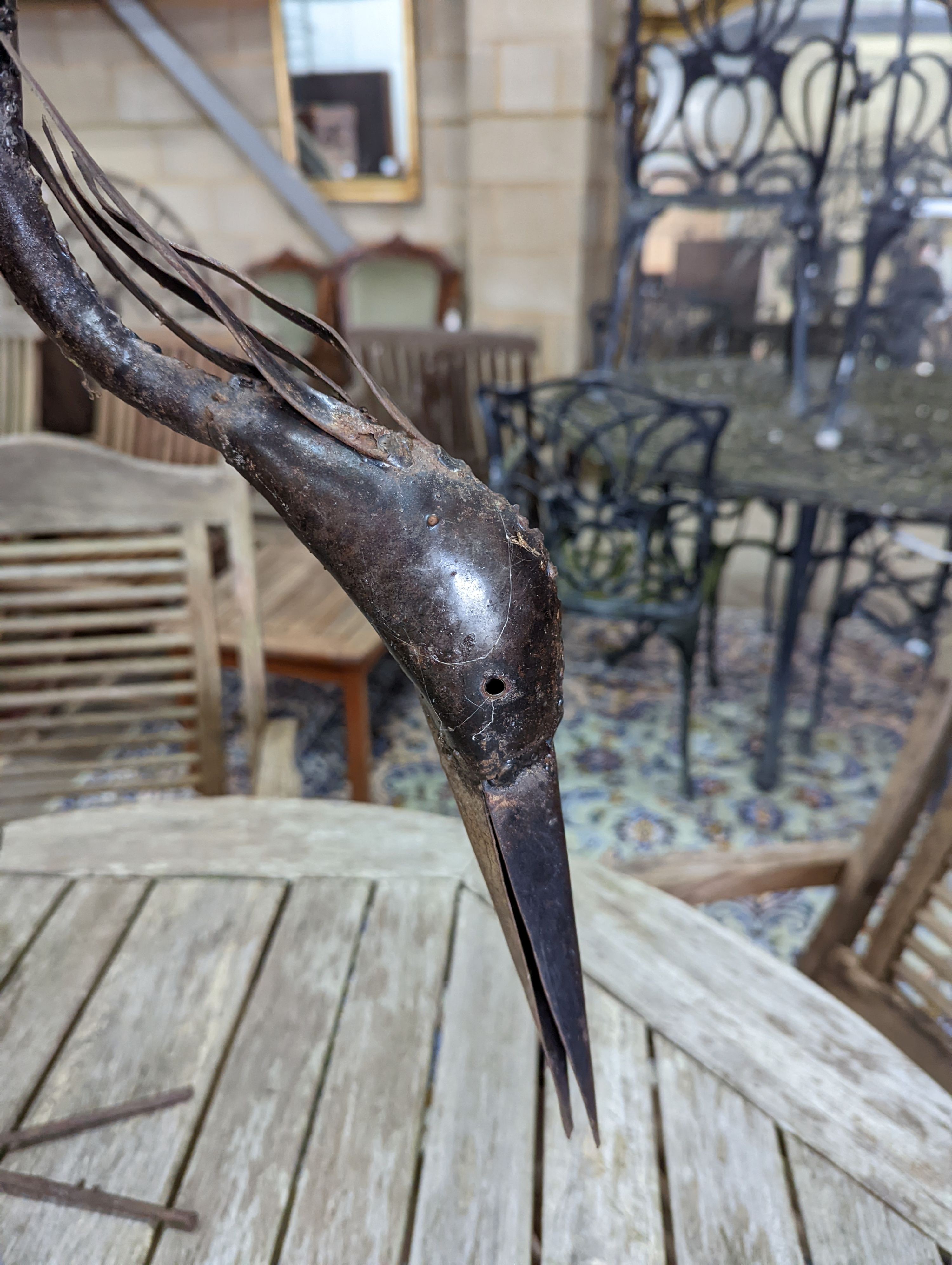 A pair of weathered metal heron garden ornaments, larger 108cm high